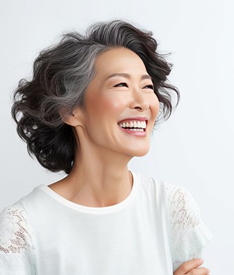 Middle-aged woman smiling after tooth removal