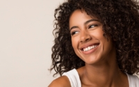 Young woman grinning and looking off to the side